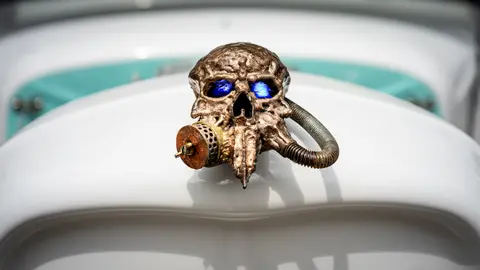 Respirator-skull hood ornament, lit eyes