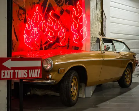 Volvo P1800 under neon flames