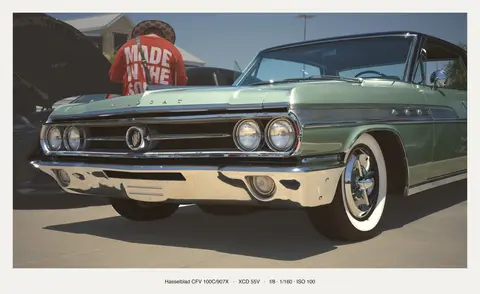 Green Buick, front three-quarter on whitewalls