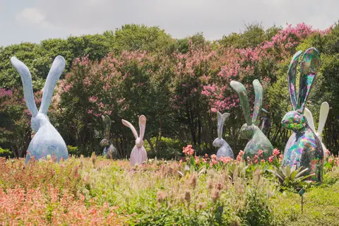 Iridescent hares in the blooming garden